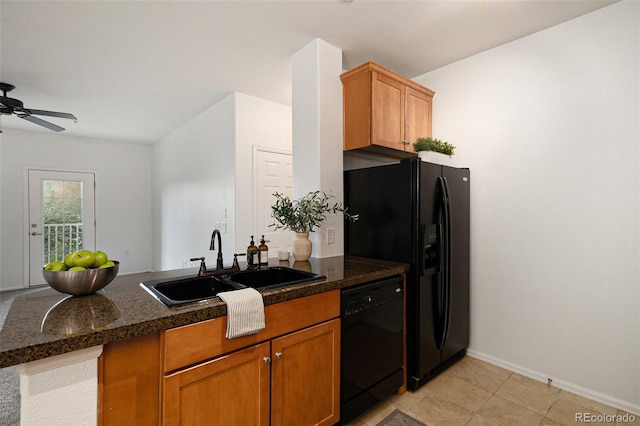 kitchen featuring sink, dark stone countertops, kitchen peninsula, ceiling fan, and black appliances