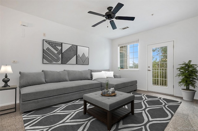 carpeted living room with ceiling fan