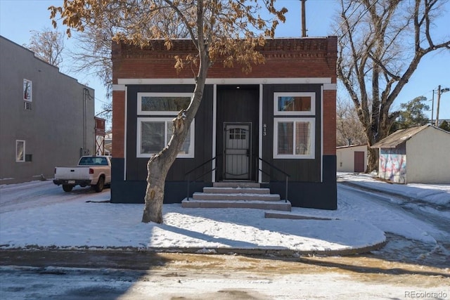 view of front of home with a shed