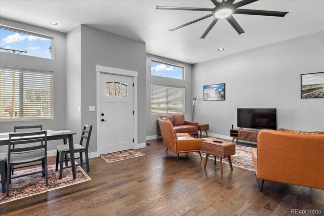 813 E B St, Pueblo, CO 81003 - living room featuring ceiling fan, a high ceiling, and dark hardwood / wood-style flooring
