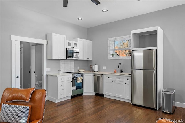 813 E B St, Pueblo, CO 81003 - kitchen with sink, white cabinets, tasteful backsplash, and appliances with stainless steel finishes