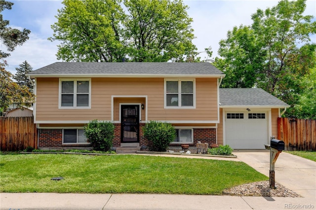 8410 Gray St, Arvada, CO 80003 - split foyer home featuring driveway, an attached garage, and brick siding
