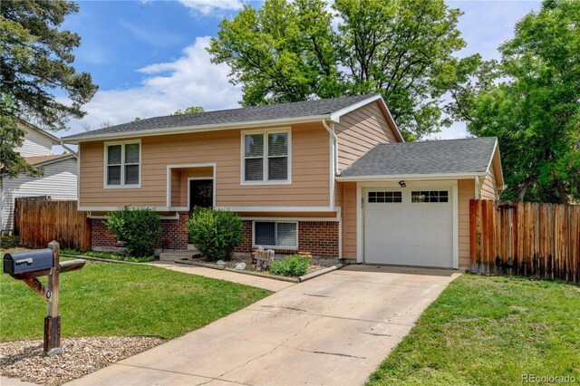 8410 Gray St, Arvada, CO 80003 - raised ranch with a garage, driveway, and brick siding