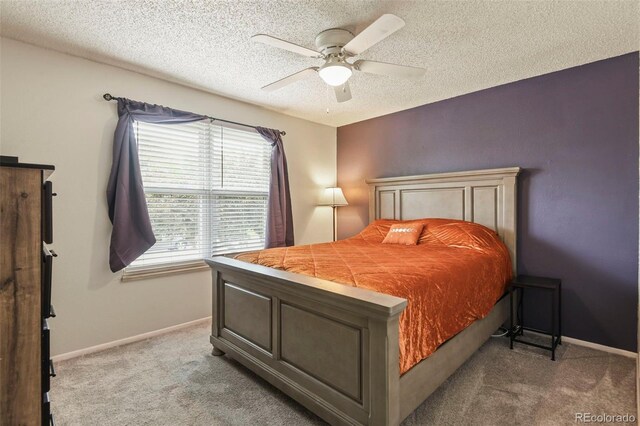 8410 Gray St, Arvada, CO 80003 - bedroom featuring light carpet, a textured ceiling, baseboards, and ceiling fan