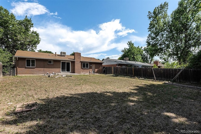 867 S Grape St, Denver, CO 80246 - back of property with a fenced backyard and brick siding