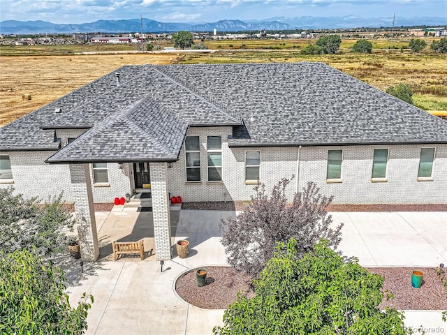 view of front of home featuring a mountain view and a patio