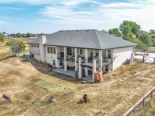 rear view of house featuring a patio area and central AC