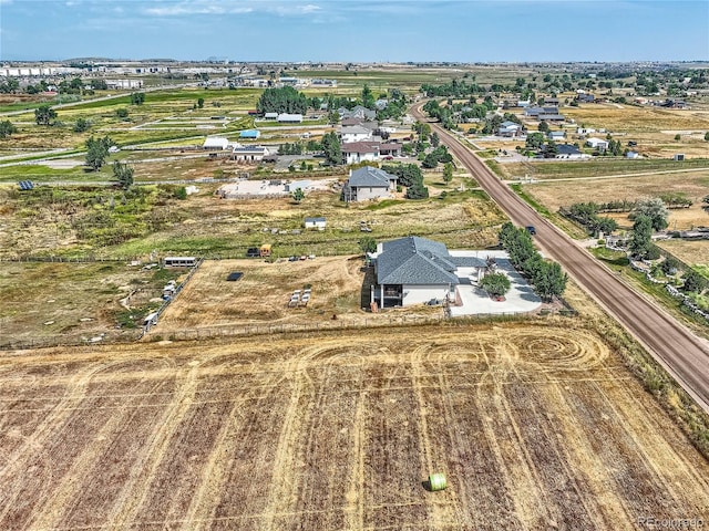 birds eye view of property with a rural view