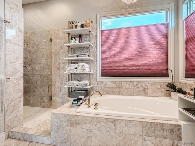 bathroom featuring separate shower and tub