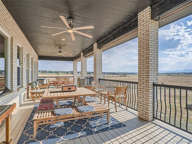 wooden terrace featuring ceiling fan