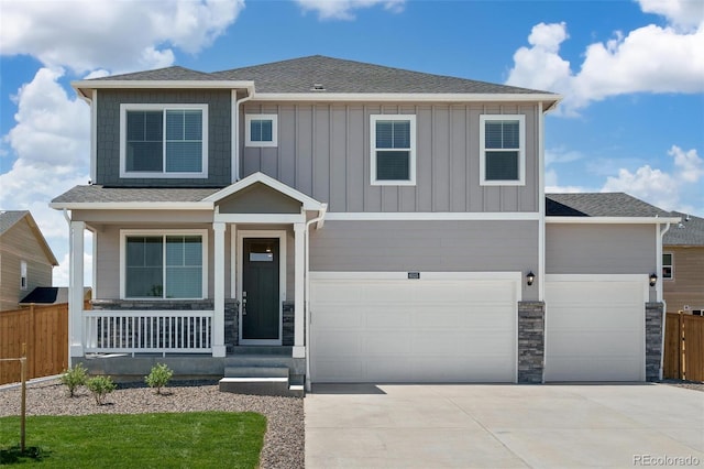 view of front of house featuring a front yard, a porch, and a garage