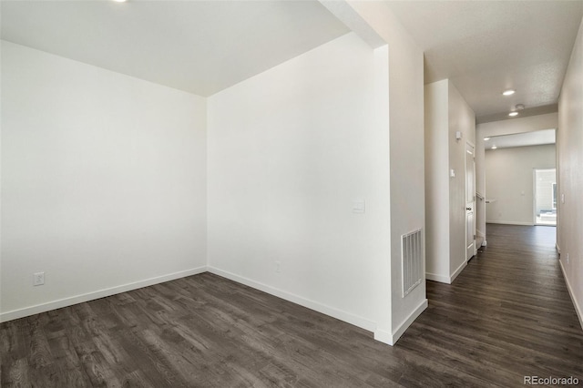 spare room with dark hardwood / wood-style floors