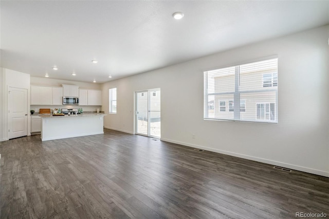 unfurnished living room with dark hardwood / wood-style floors