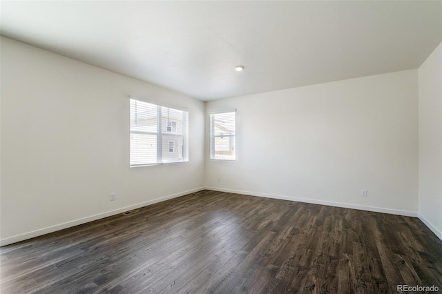 spare room featuring dark hardwood / wood-style floors