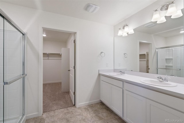 bathroom featuring vanity and an enclosed shower