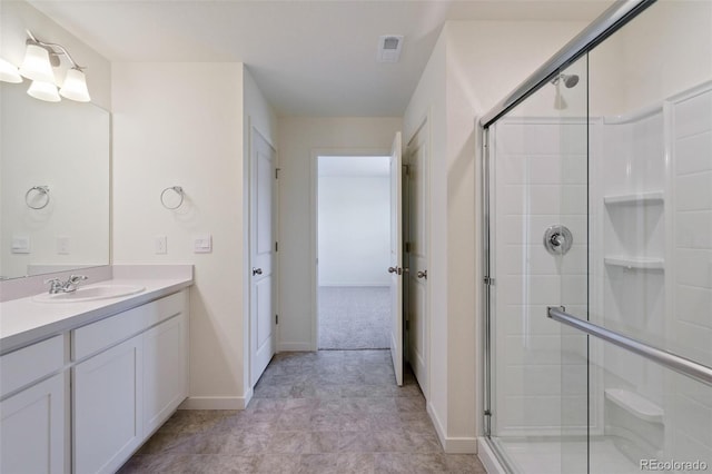 bathroom with vanity and a shower with shower door