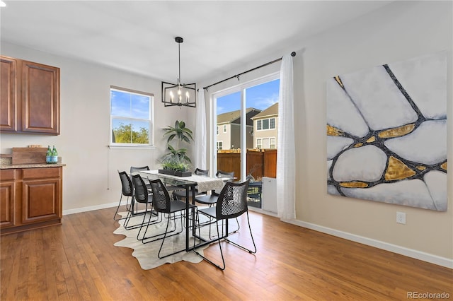 dining space with a notable chandelier and wood-type flooring