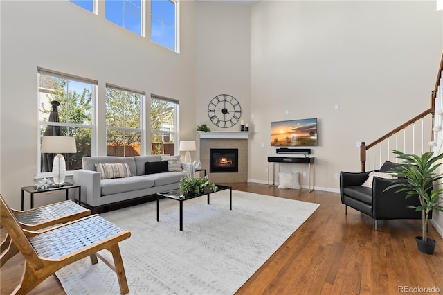 living room featuring wood-type flooring and a tile fireplace