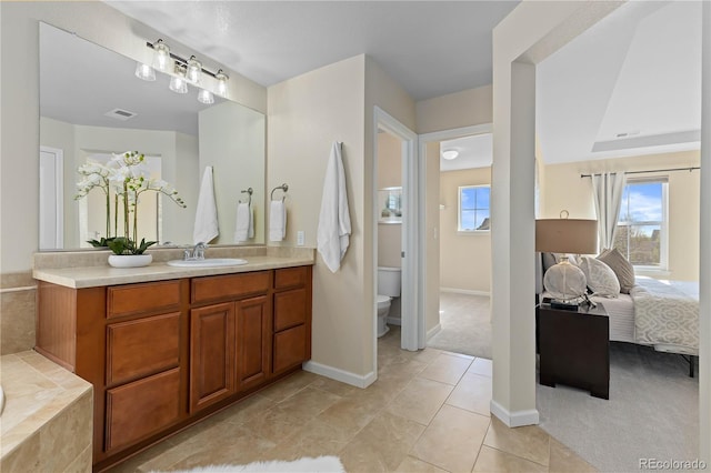 bathroom featuring vanity, tile patterned floors, and toilet