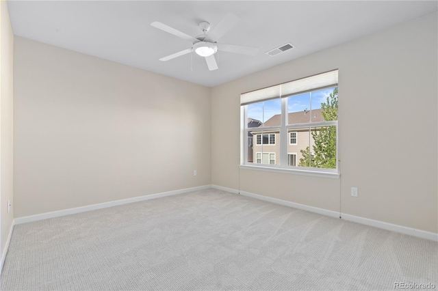 carpeted spare room with ceiling fan