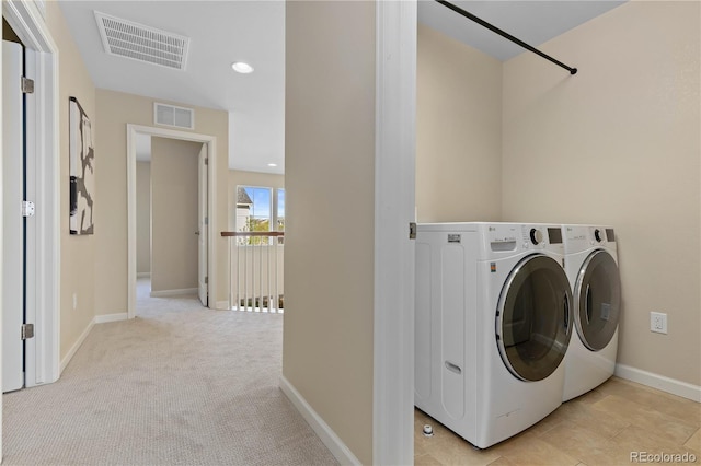 washroom featuring separate washer and dryer and light carpet