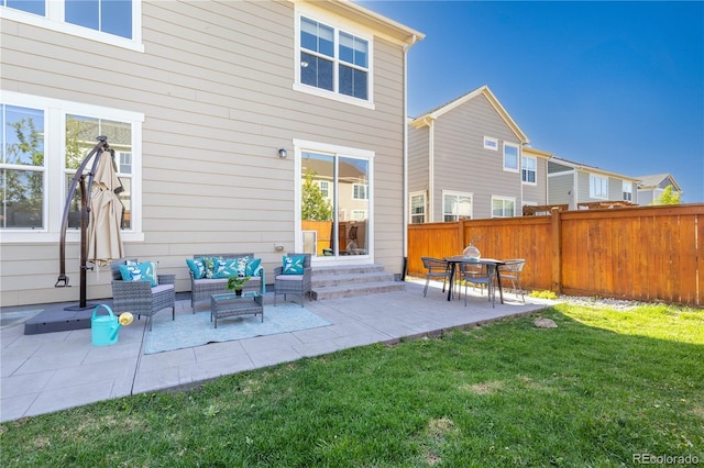 back of house featuring an outdoor hangout area, a patio, and a lawn