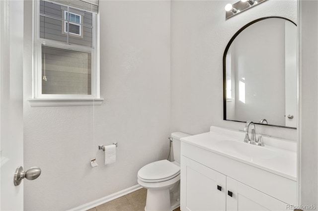 bathroom featuring tile patterned floors, vanity, and toilet