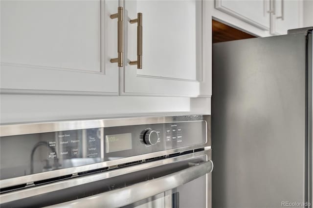 interior details featuring white cabinetry and appliances with stainless steel finishes