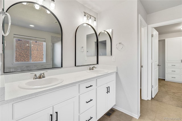 bathroom with tile patterned flooring and vanity