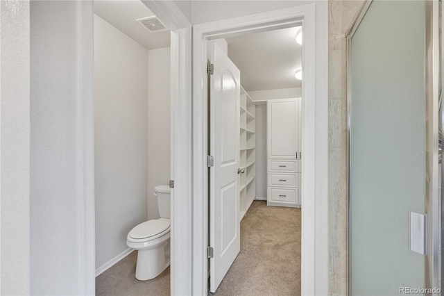 bathroom with toilet and an enclosed shower