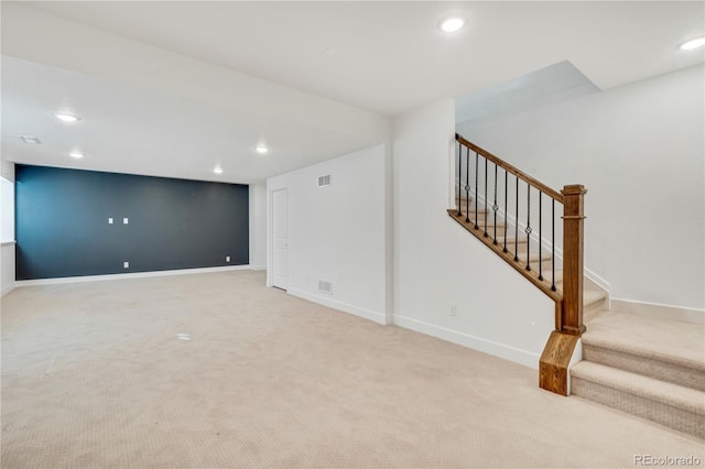 basement featuring light carpet