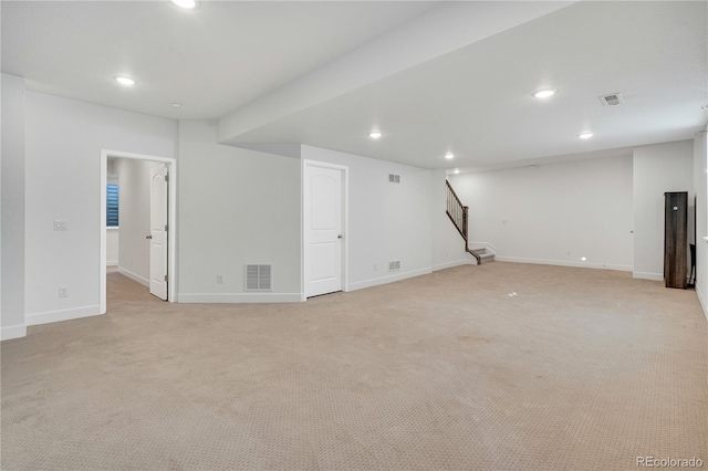 basement featuring light carpet