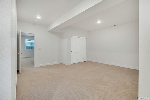 bonus room with light colored carpet