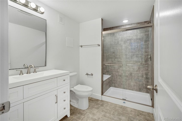 bathroom featuring vanity, toilet, and an enclosed shower