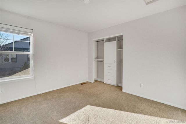 unfurnished bedroom with carpet flooring and a closet