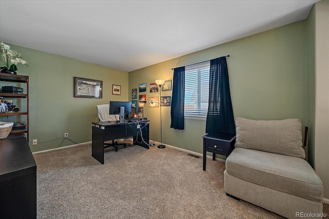 carpeted office featuring visible vents and baseboards