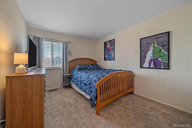 carpeted bedroom with visible vents and baseboards