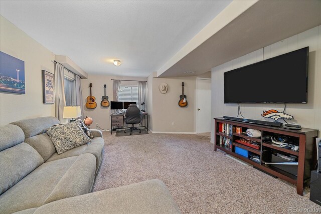 living room with carpet floors, a textured ceiling, and baseboards