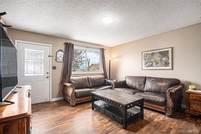547 S 3rd Ave, Brighton, CO 80601 - living area with wood finished floors, a textured ceiling, and baseboards