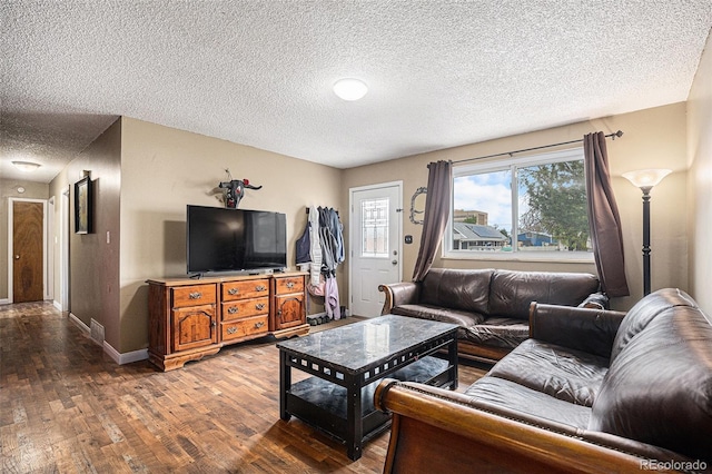 547 S 3rd Ave, Brighton, CO 80601 - living room with wood finished floors, a textured ceiling, and baseboards