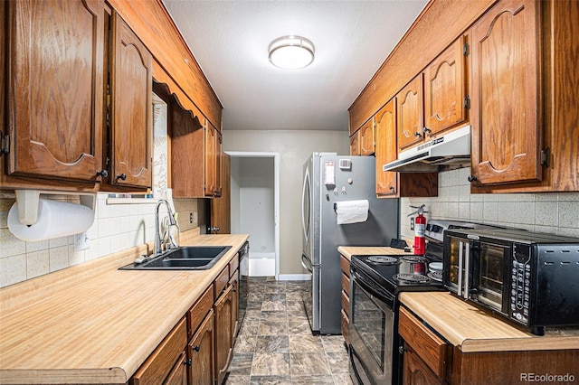 547 S 3rd Ave, Brighton, CO 80601 - kitchen with a sink, under cabinet range hood, light countertops, and decorative backsplash