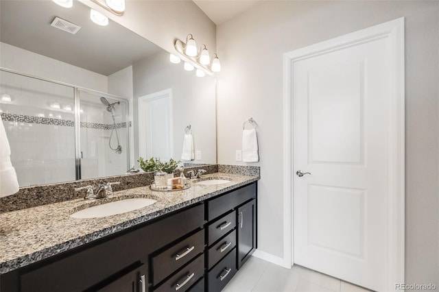 bathroom with vanity, tile patterned flooring, and an enclosed shower