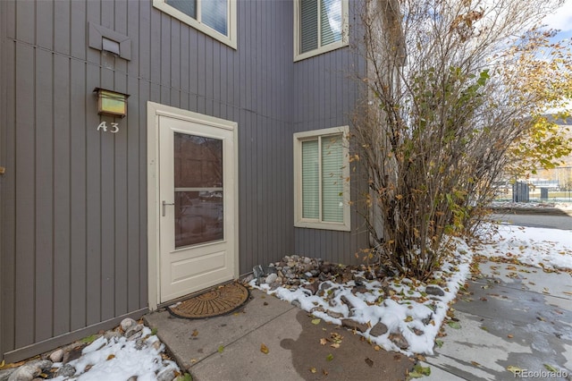 view of snow covered property entrance