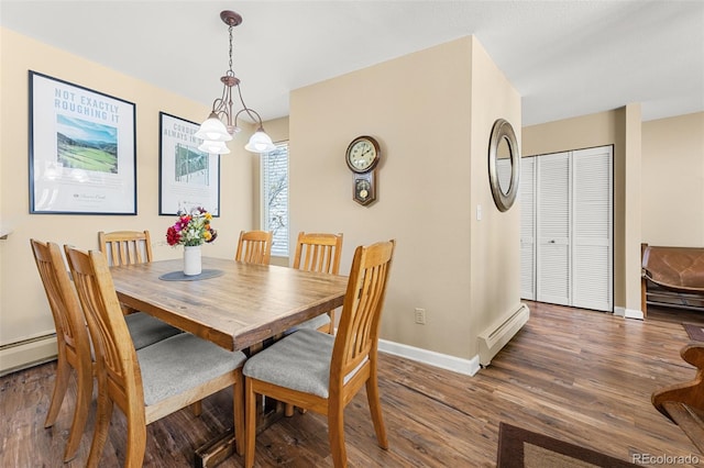 dining space with baseboard heating, a chandelier, and dark hardwood / wood-style flooring