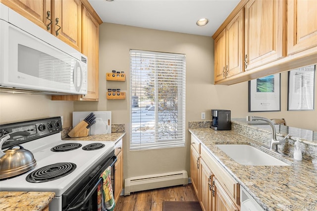 kitchen with sink, baseboard heating, light wood-type flooring, light brown cabinetry, and white appliances