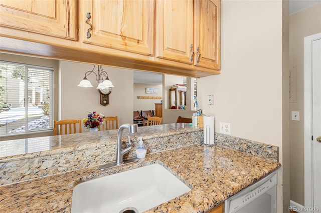 kitchen featuring white dishwasher, an inviting chandelier, sink, light stone countertops, and light brown cabinetry