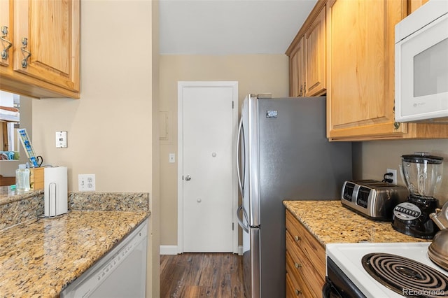 kitchen with dark hardwood / wood-style floors, white appliances, and light stone countertops