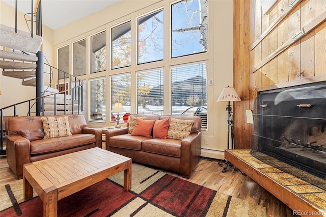 142 Eagle Dr Unit A3, Avon, CO 81620 - living room with wood finished floors, a high ceiling, a fireplace with raised hearth, and stairs