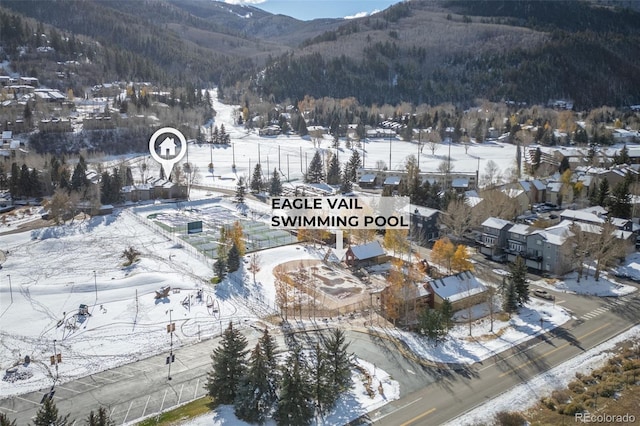 snowy aerial view with a mountain view