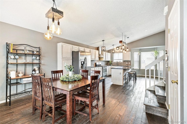 dining room with baseboards, stairway, vaulted ceiling, a textured ceiling, and dark wood-style flooring